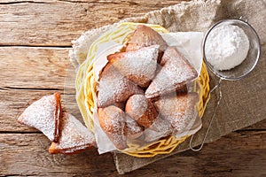 Mandazi, also known as theÂ daboÂ orÂ South Sudanese Coconut Doughnut close-up in a basket. Horizontal top view